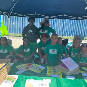 Kids standing behind a table